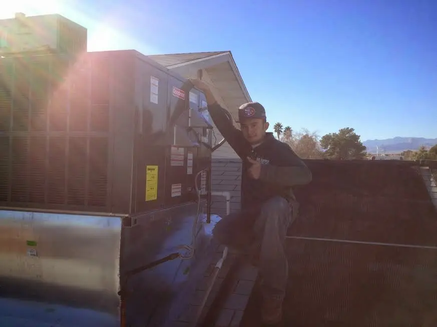 HVAC technician performing HVAC Inspection on a rooftop unit in Garfield Heights